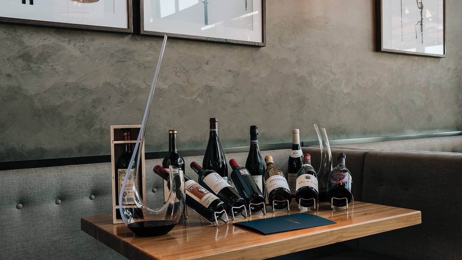 Wine bottles and a decanter arranged on a table in the restaurant at Four Seasons Resort and Residences Napa Valley