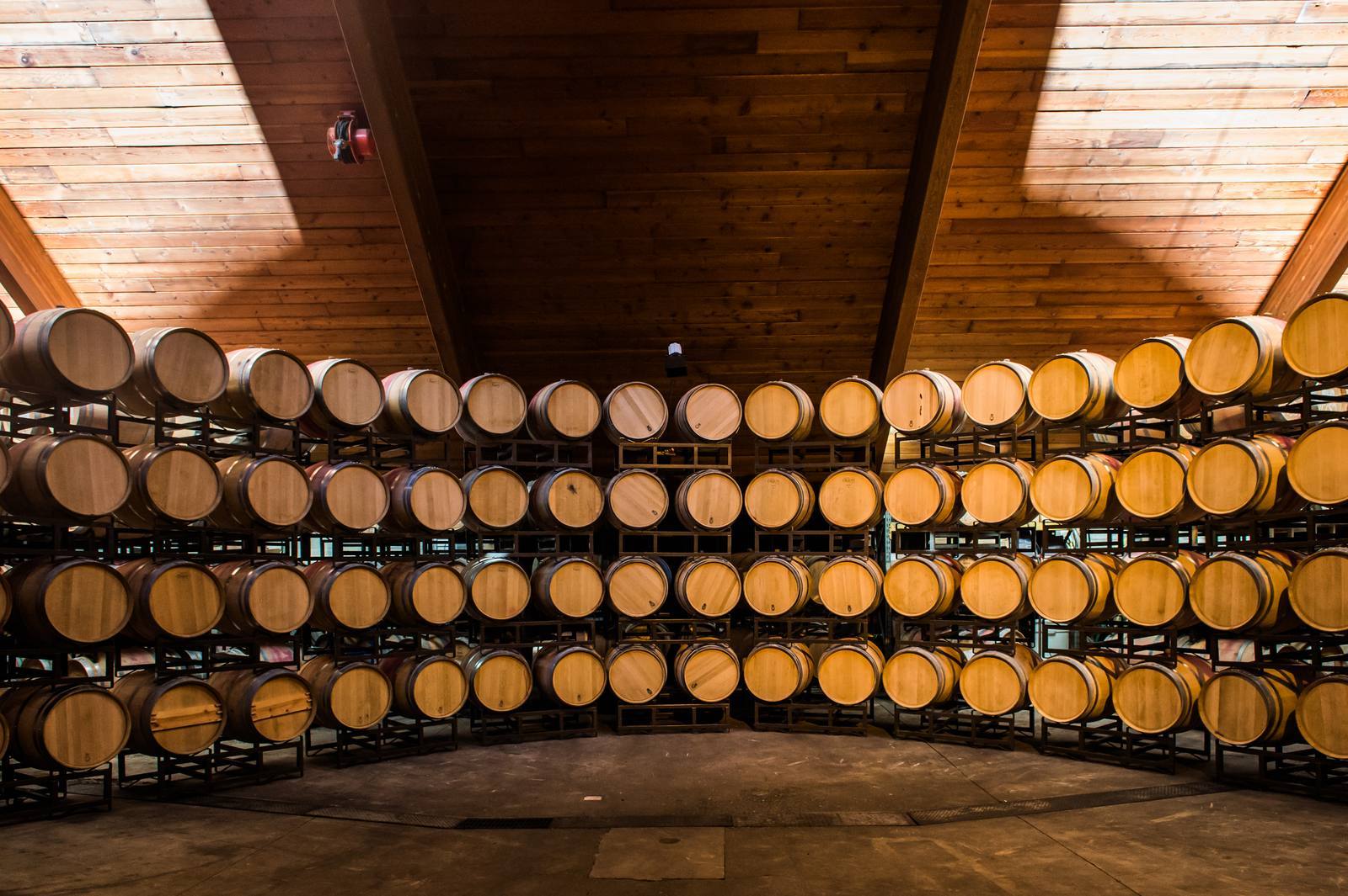 Oak barrels stacked in the barrel hall at Chappellet Winery