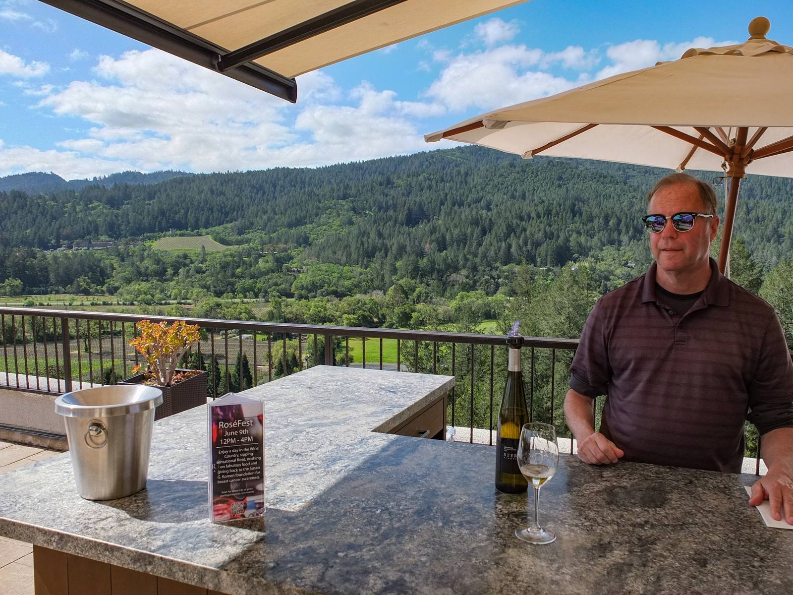 A visitor tasting wine on the terrace at Sterling Vineyards