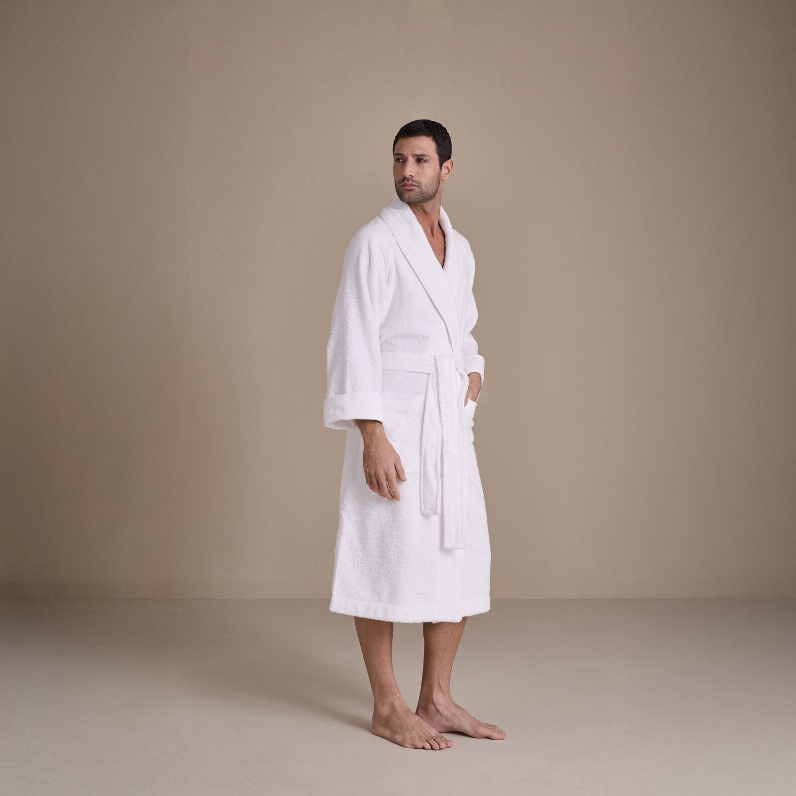 The Frette Unito Shawl Collar Bathrobe in white, shown belted with turned back cuffs